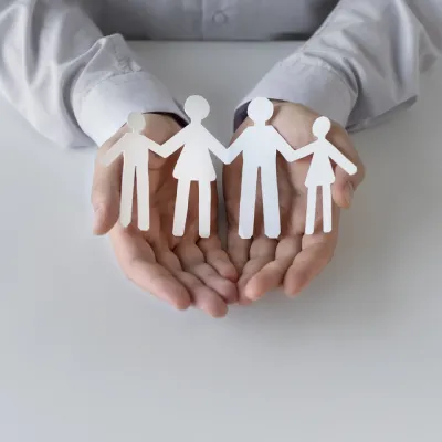 cut out of four humans in hands